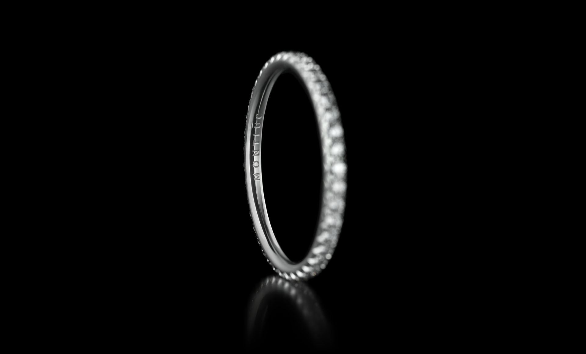 Montluc - Halo No.1 diamond ring, viewed from an angle, with engravement in focus